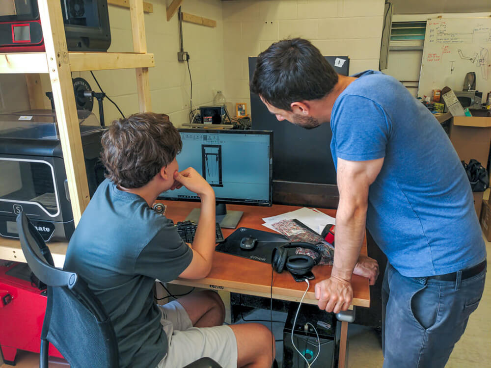 Dave helping ones of our summer interns with some CAD