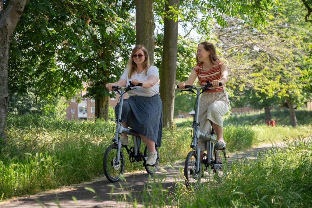 Friends riding through the park on a FLIT M2 folding ebike