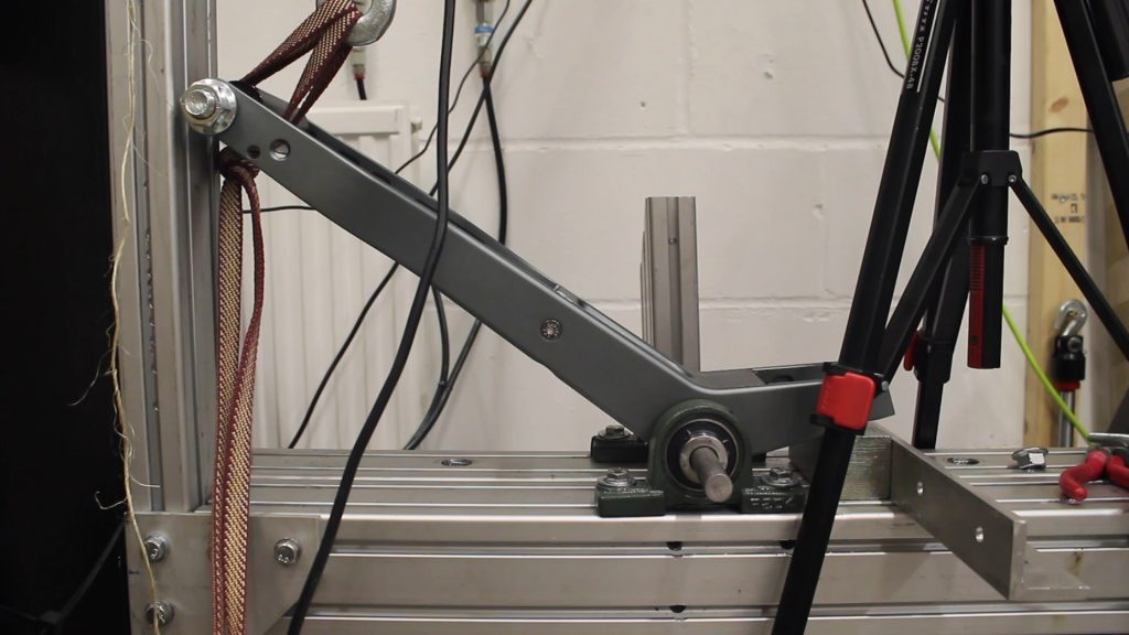 The FLIT M2's rear swing arm being testing on a rig at FLIT's Cambridge workshop and HQ